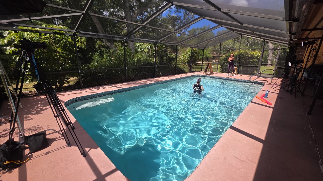 Filming a water exercise video with half and full pool noodles, for the Poolfit app.