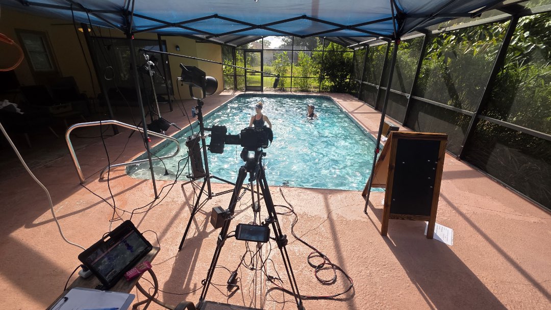 Filming an aqua aerobic video that can be performed in both deep and shallow water.